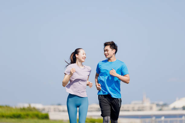 istock Young Asian adults jogging outdoors 1677541532