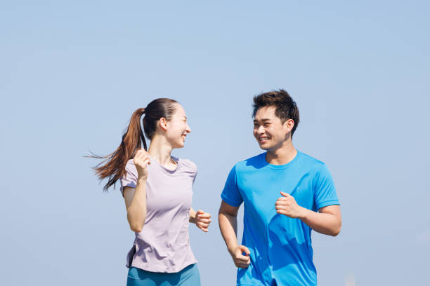 Young Asian adults jogging outdoors
