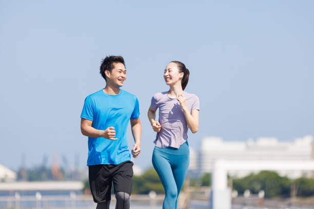 istock Young Asian adults jogging outdoors 1677541643