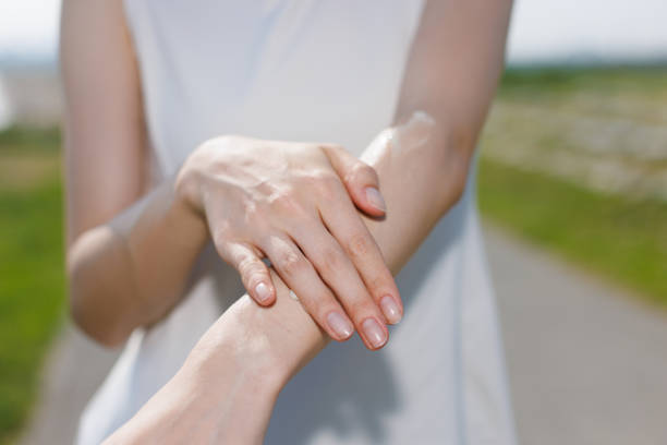 istock Young Asian woman applying sunblock on hand 1677543823