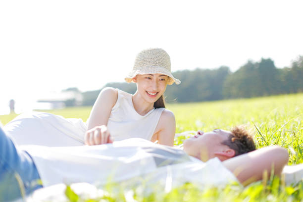 Young Asian couple relaxing outdoors during summer