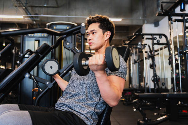 istock Young Asian man training with dumbbells 1677548684
