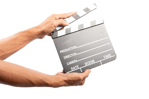 Black male hands holding film clapper isolated on white