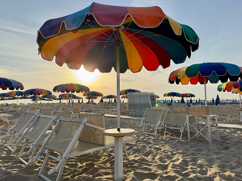 Multi colored beach umbrella during sunrise