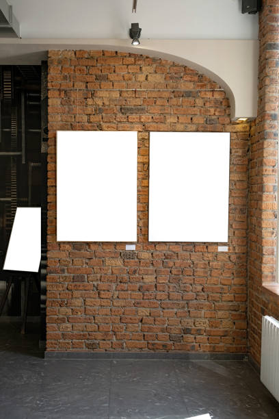 istock Blank picture frames on brick wall with glowing lamp, mock up 1677569446