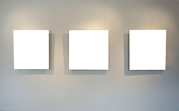 istock Blank picture frames on grey wall with glowing lamp, mock up 1677569957