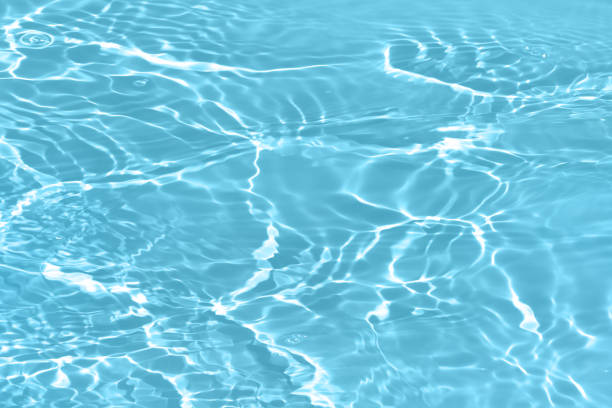 istock Defocus blurred transparent blue colored clear calm water surface texture with splashes and bubbles. Trendy abstract nature background. Water waves in sunlight with copy space. Blue watercolor shining 1677602754