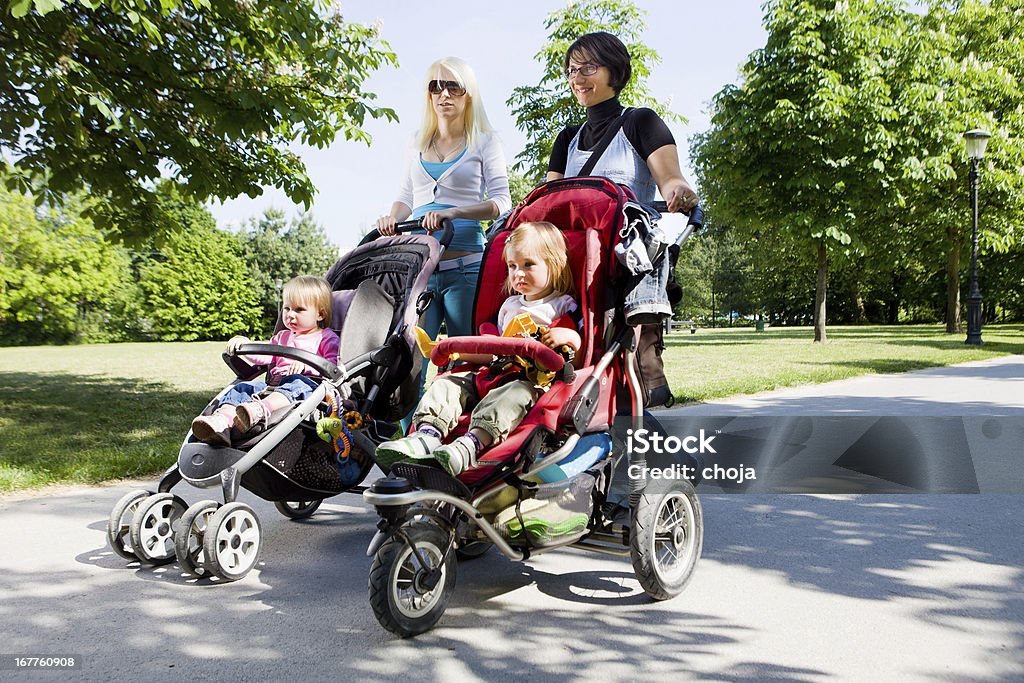 Молодые матери в парке Ходьба их младенцев - Стоковые фото Мать роялти-фри