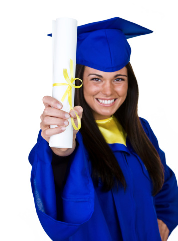 Cheerful young woman wearing her graduation cap and gown and holding up her diploma 