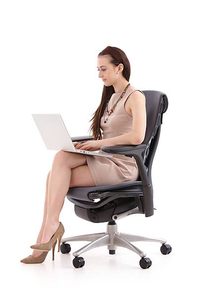 Female office worker using laptop stock photo