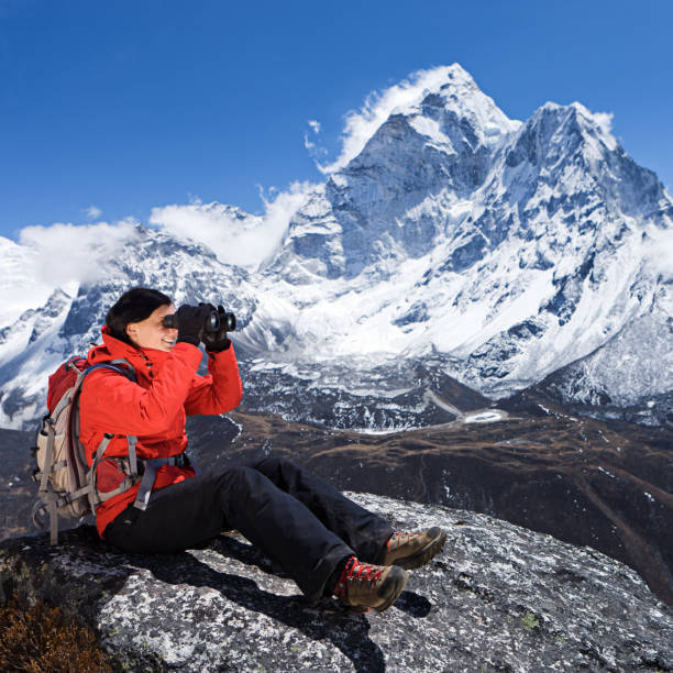 istock Woman is looking through binoculars in Mount Everest National Park 167761336