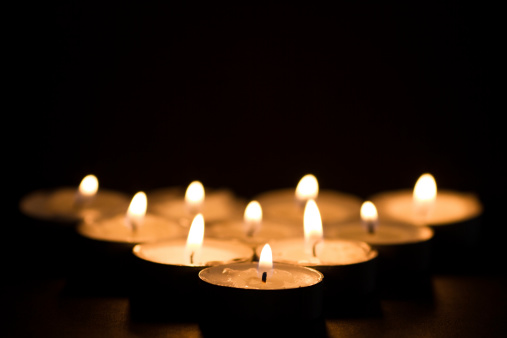 Lighted candles on a black background. Low DOF.