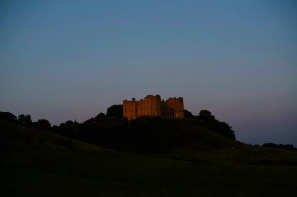 istock Yellow House on a hill at Twilight 1677613919