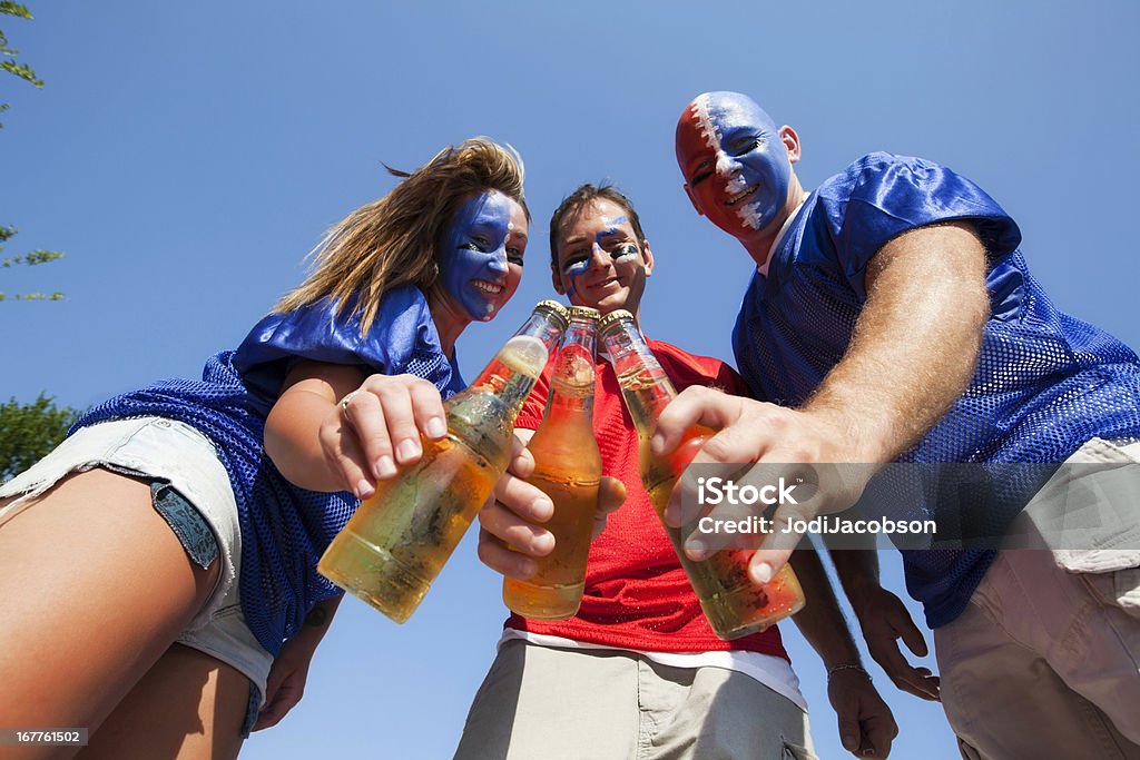 Football Tailgate party beer toast happy friends opening and toasting bottles of beer at a tailgate party Tailgate Party Stock Photo