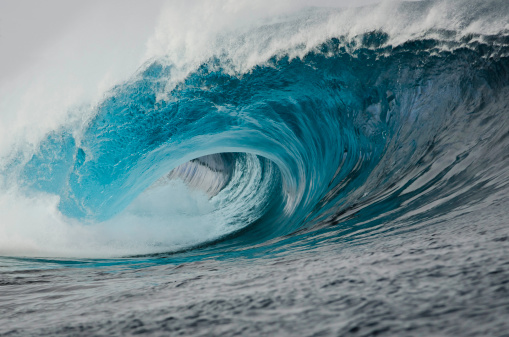 A powerful blue wave crushes the reef.