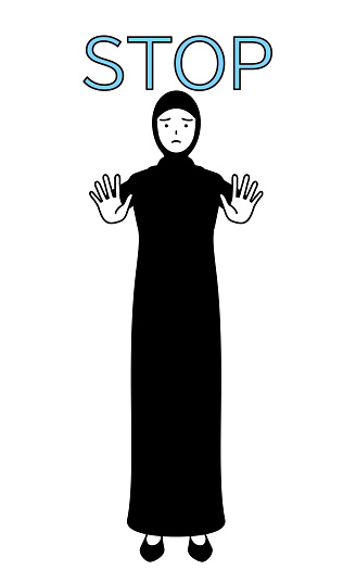 Muslim Woman with her hands out in front of her body, signaling a stop.
