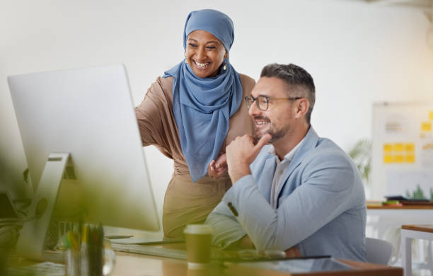 istock Training, help and computer with business people in office for creative, diversity and coaching. Teamwork, collaboration and feedback with employees in digital agency for website, mentor and designer 1677633646