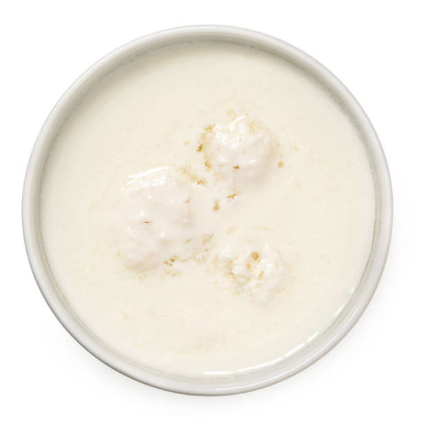 istock Milk with kefir grains in a white ceramic bowl isolated on white from above. 1677642746