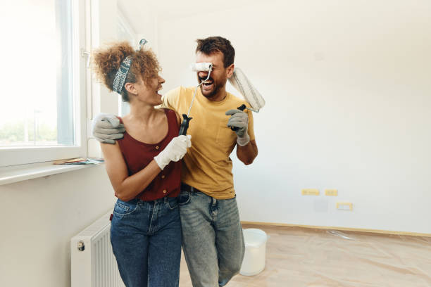 istock Cheerful couple having fun during home renovation process. 1677656016