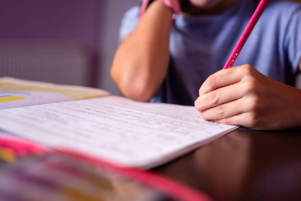 istock Close up girl doing homework 1677656595