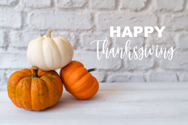 istock Thanksgiving background. Mockup with pumpkins and fall leaves over white wall with copy-space. 1677663538