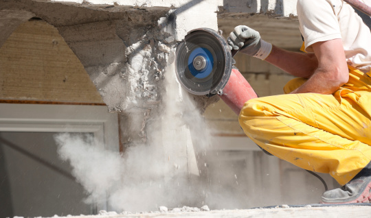 A grinder cutting a concrete with dust coming from it. Full Frame Camera And L Glass Used.