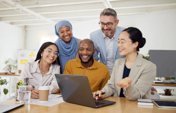 istock Business people, computer and teamwork or planning for marketing, website design and presentation in office. Group of men and woman on laptop for online news, startup meeting or project collaboration 1677684330