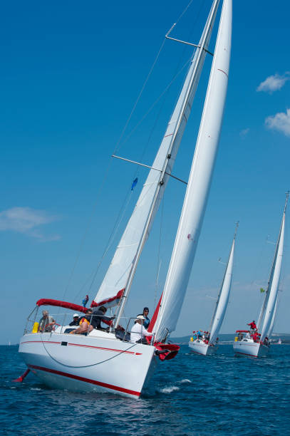 Front view of large number of sailboats sailing against the wind using main sail and genoa, Adriatic sea, Europe
