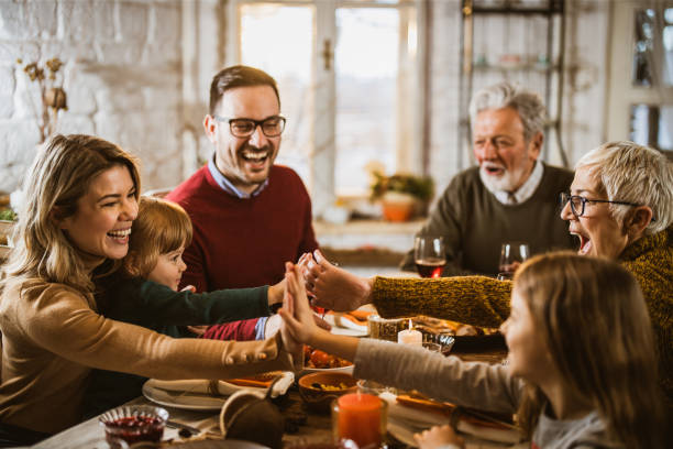 istock Happy extended family having fun during lunch at dining table. 1677692890