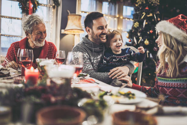 istock Happy extended family having fun during a meal on New Year. 1677694036