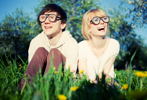 Laughing couple wearing funny glasses