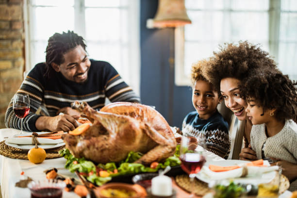 istock Happy black family talking during Thanksgiving meal at dining table. 1677696843