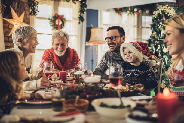 istock Happy extended family talking during New Year's meal at dining table. 1677698590