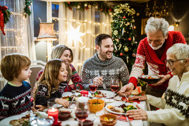 istock Happy extended family enjoying during New Year's meal at dining table. 1677707607