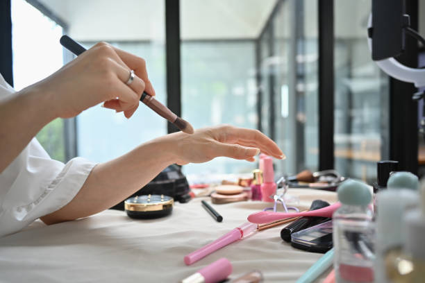 istock Beauty blogger holding a makeup brush in front of camera while speaking about cosmetic tools while recording video at home 1677708204