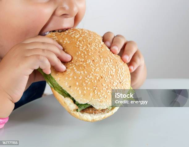 Piccolo Ragazza Caucasica Mangiare Hamburger - Fotografie stock e altre immagini di Bambino - Bambino, Fast food - Cibo da asporto, Sovrappeso