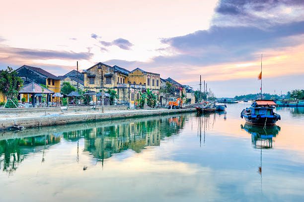 Thu Bon river, Hoi An, Vietnam water reflections Boat and buildings reflection in morning, Hoi An, Vietnam. HDR thu bon river stock pictures, royalty-free photos & images