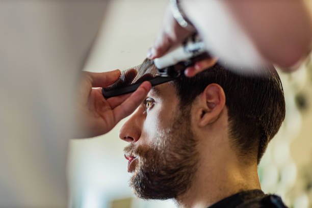 istock Young man having a haircut at barber shop. 1677712128