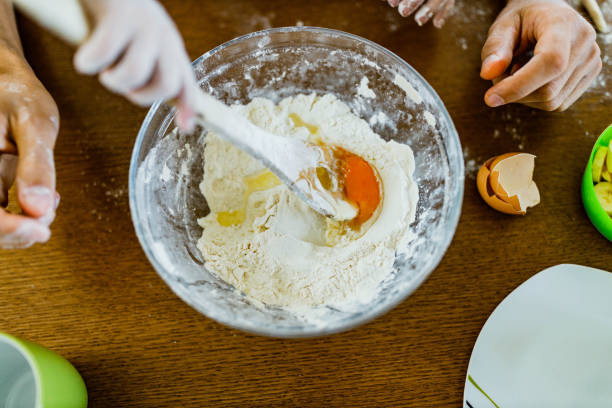 깨진 달걀 노른자와 그릇에 밀가루. - eggs bowl cracked dining table 뉴스 사진 이미지