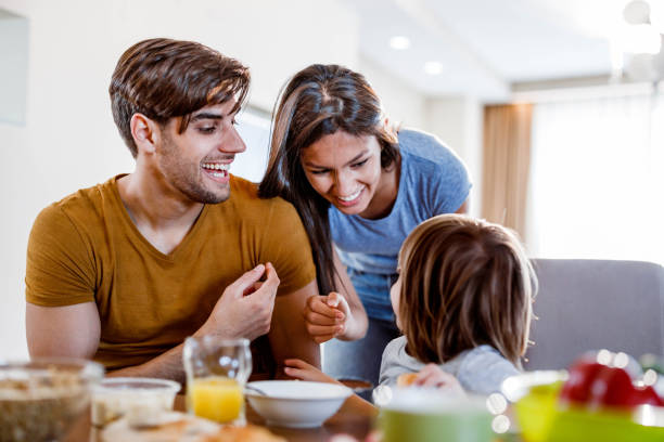 istock Young happy family having fun during breakfast in dining room. 1677715348