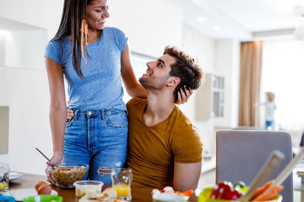 istock Happy couple in love talking during breakfast time at dining table. 1677716359