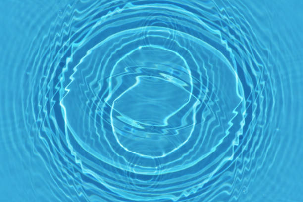 istock Defocus blurred transparent blue colored clear calm water surface texture with splashes and bubbles. Trendy abstract nature background. Water waves in sunlight with copy space. Blue watercolor shining 1677724435