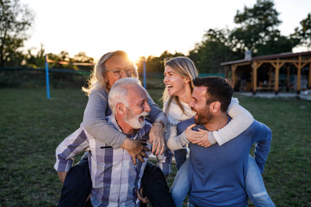 istock Playful couples having fun while piggybacking in nature. 1677725006