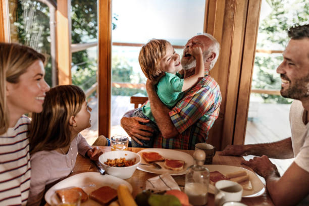 Grandfather at home playing with his granddaughter.