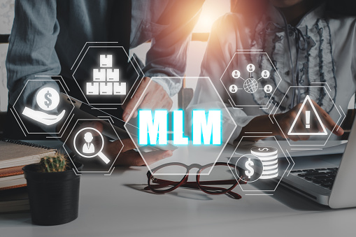 MLM, multi level marketing concept, Business team  analysis summary graph reports of business operating expenses with multi level marketing icon on virtual screen.