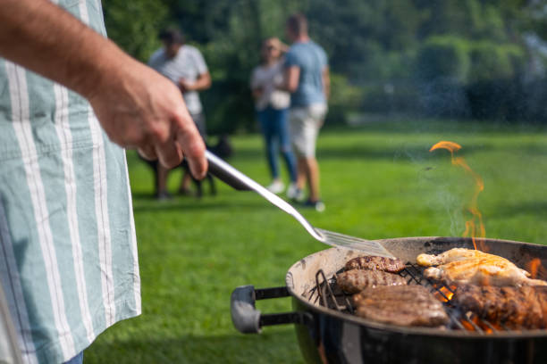 istock Man roasting burgers 1677753308