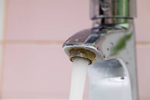 istock Flowing tap water run from corrosive steel spigot, flow on pink backdrop. Plumbing, bathroom apparatus and water flood 1677762995