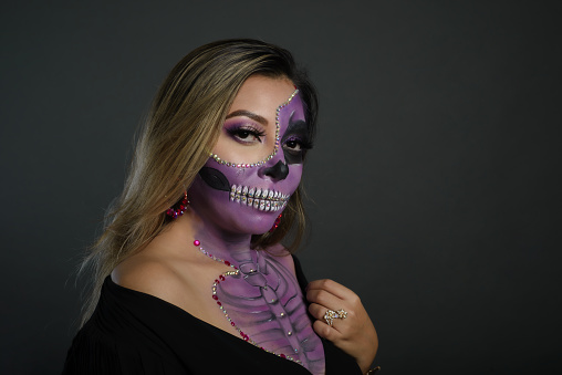 Santa Muerte, day of the dead character. Portrait of a woman with sugar skull makeup. Halloween make-up. Portrait of Calavera Catrina
