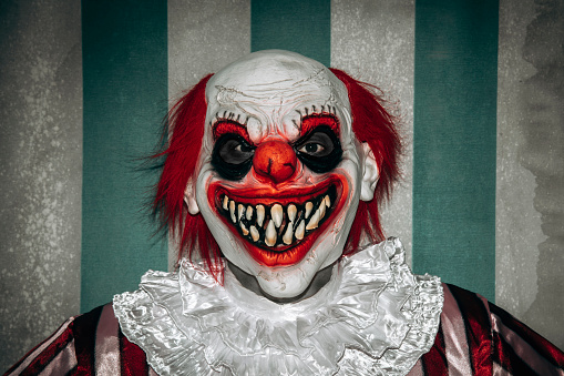 A stock photo of a creepy evil vampire clown against a dark textured background.\n[url=http://www.istockphoto.com/search/lightbox/10593020#1071a130][IMG]http://www.bellaorastudios.com/banners/new01.jpg[/IMG][/url]