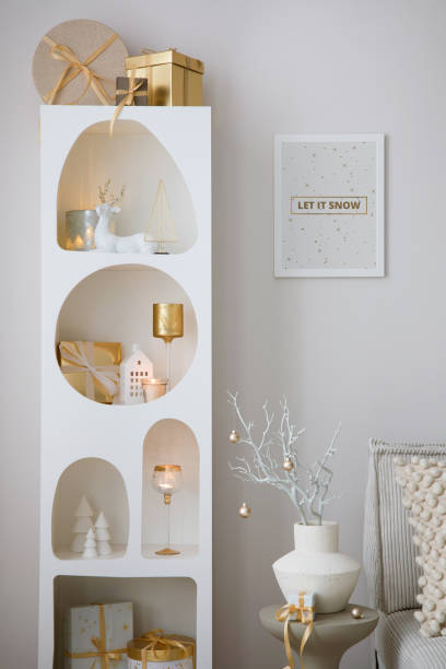 istock Beautiful composition on white design shelf with christmas decoration, lights, gifts, lanterns ,deer, candles, stars and accessories. Mock up poster frame. Santa claus is coming. Template. 1677789682
